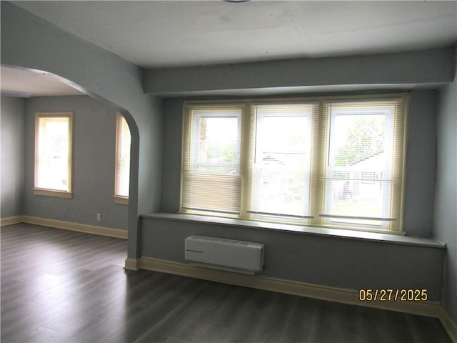 2119 N 32nd St Unit K, Kansas City, KS 66104 - spare room with arched walkways, dark wood finished floors, healthy amount of natural light, and baseboards