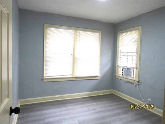 2119 N 32nd St Unit K, Kansas City, KS 66104 - empty room featuring wood finished floors, baseboards, and cooling unit