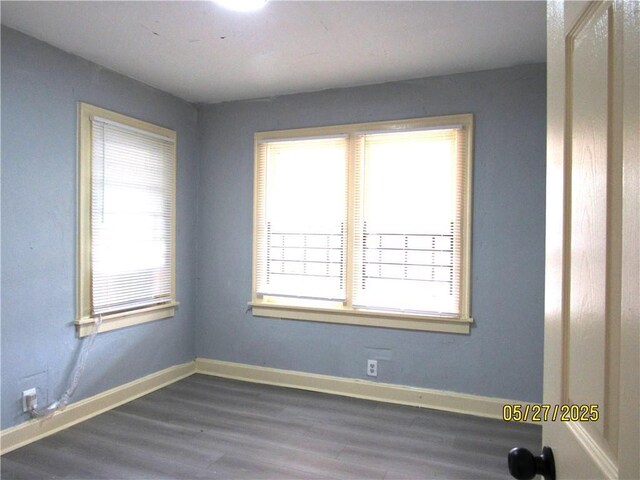 2119 N 32nd St Unit K, Kansas City, KS 66104 - spare room featuring dark wood-type flooring and baseboards