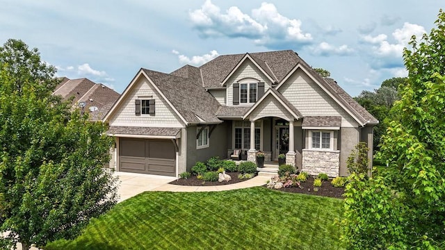 16005 Melrose St, Overland Park, KS 66221 - craftsman-style house featuring a porch, concrete driveway, a front lawn, a garage, and stucco siding