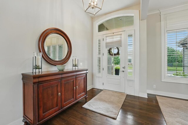 16005 Melrose St, Overland Park, KS 66221 - foyer with a chandelier, dark wood-style floors, and crown molding