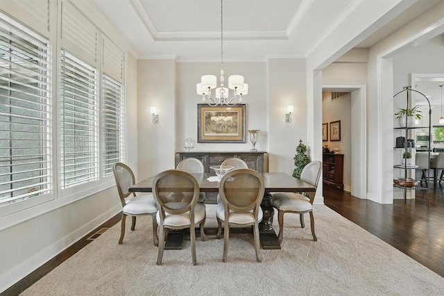 16005 Melrose St, Overland Park, KS 66221 - dining space with a chandelier, wood finished floors, a tray ceiling, and crown molding