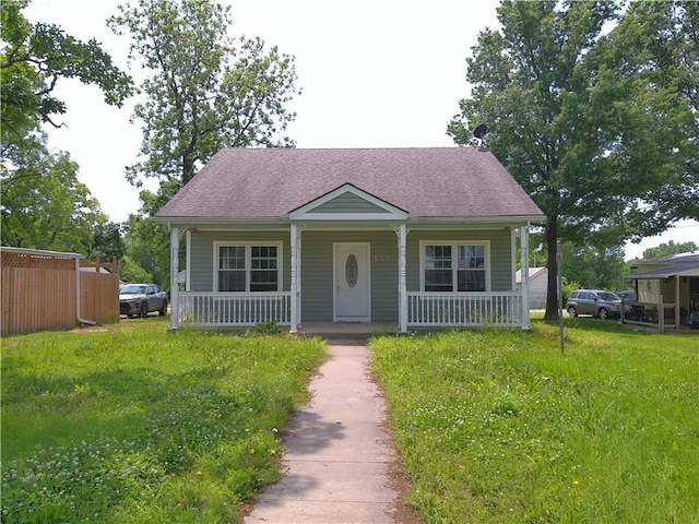 503 W Shawnee St, Paola, KS 66071 - bungalow with covered porch and a shingled roof