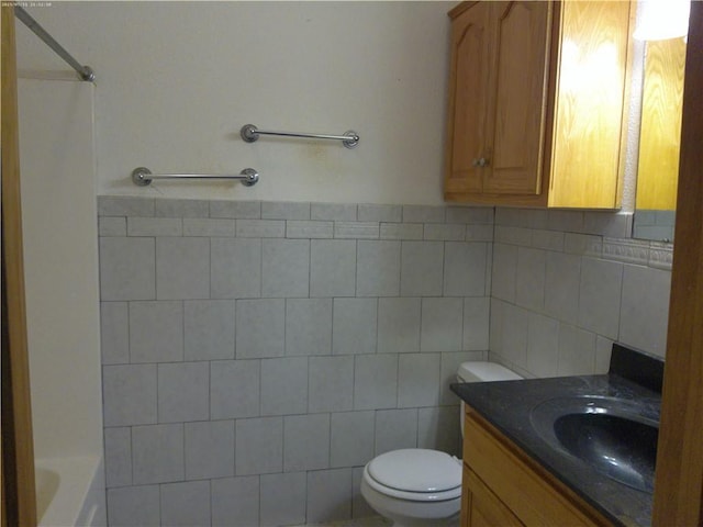 503 W Shawnee St, Paola, KS 66071 - bathroom with tile walls, toilet, and vanity
