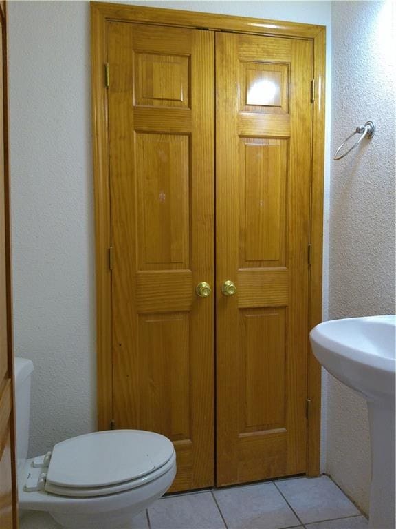 503 W Shawnee St, Paola, KS 66071 - bathroom featuring toilet and tile patterned flooring
