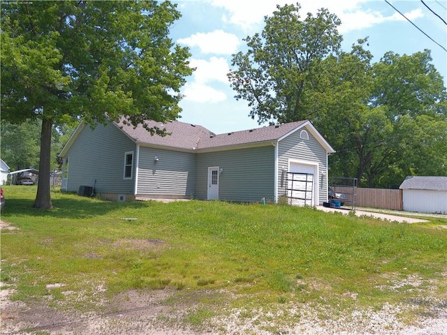 503 W Shawnee St, Paola, KS 66071 - rear view of property with an attached garage and central air condition unit