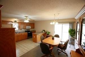 814 Clancy Ct, Raymore, MO 64083 - dining area featuring a ceiling fan and a chandelier