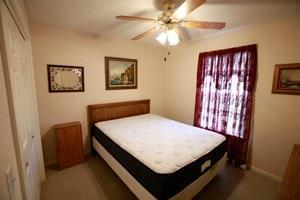 814 Clancy Ct, Raymore, MO 64083 - bedroom featuring a ceiling fan, baseboards, and a closet