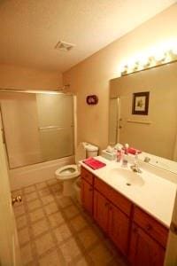 814 Clancy Ct, Raymore, MO 64083 - bathroom featuring vanity, toilet, and combined bath / shower with glass door