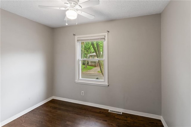 6401 E 120th Ter, Grandview, MO 64030 - empty room featuring dark wood-style flooring, baseboards, a textured ceiling, and a ceiling fan