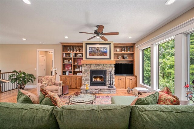 11408 NE 113th Ter, Liberty, MO 64068 - living room with light wood-type flooring, recessed lighting, a ceiling fan, and a stone fireplace