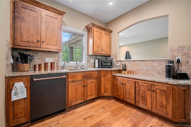 11408 NE 113th Ter, Liberty, MO 64068 - kitchen with dishwashing machine, backsplash, light wood-style floors, light stone countertops, and brown cabinetry
