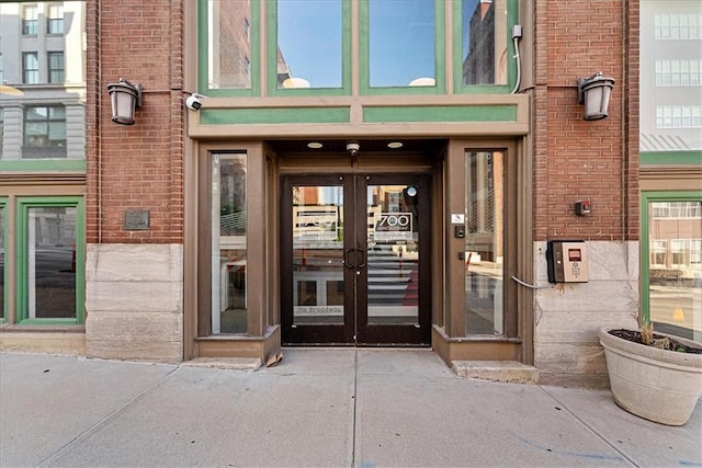 700 Broadway Blvd Unit 507, Kansas City, MO 64105 - view of exterior entry with french doors, brick siding, and a security system