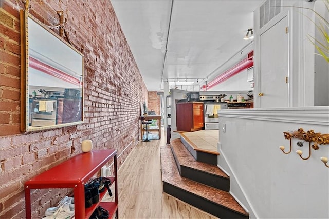 700 Broadway Blvd Unit 507, Kansas City, MO 64105 - hall with brick wall and light wood-style floors