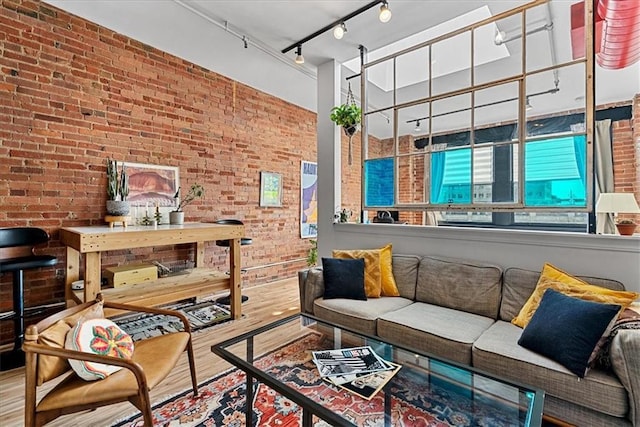 700 Broadway Blvd Unit 507, Kansas City, MO 64105 - living area with brick wall and wood finished floors