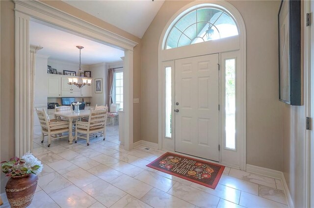 309 E 126th St, Kansas City, MO 64145 - entrance foyer with a chandelier and light marble finish flooring
