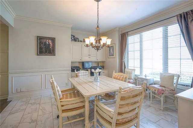 309 E 126th St, Kansas City, MO 64145 - dining room with light marble finish floors, a chandelier, plenty of natural light, crown molding, and wainscoting