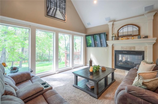 309 E 126th St, Kansas City, MO 64145 - living area with high vaulted ceiling, a fireplace, healthy amount of natural light, and carpet floors