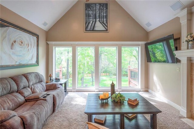 309 E 126th St, Kansas City, MO 64145 - carpeted living room featuring high vaulted ceiling and ornate columns