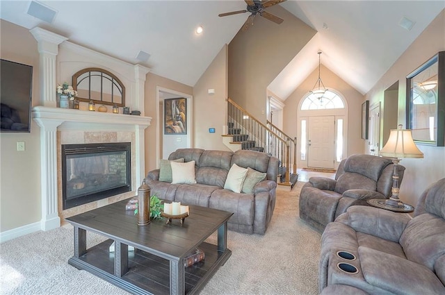 309 E 126th St, Kansas City, MO 64145 - living room with carpet floors, a ceiling fan, a fireplace, stairs, and high vaulted ceiling