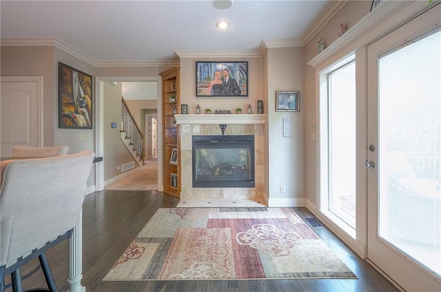 309 E 126th St, Kansas City, MO 64145 - living area with dark wood-style floors, french doors, a fireplace, crown molding, and stairs