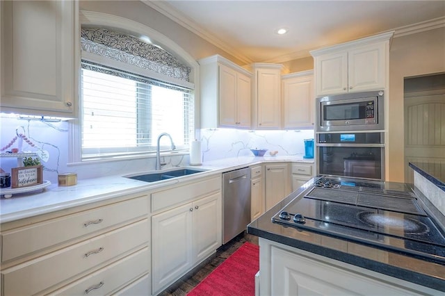 309 E 126th St, Kansas City, MO 64145 - kitchen featuring stainless steel appliances, white cabinetry, decorative backsplash, crown molding, and recessed lighting