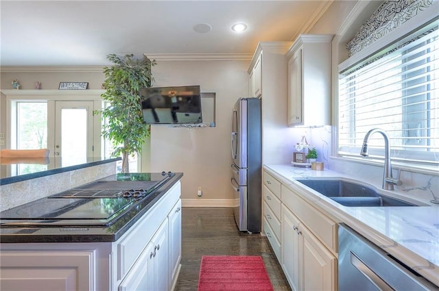 309 E 126th St, Kansas City, MO 64145 - kitchen with stainless steel appliances, white cabinetry, dark wood finished floors, light stone counters, and crown molding