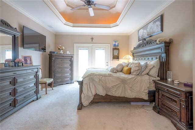 309 E 126th St, Kansas City, MO 64145 - bedroom with light colored carpet, a tray ceiling, multiple windows, access to outside, and crown molding