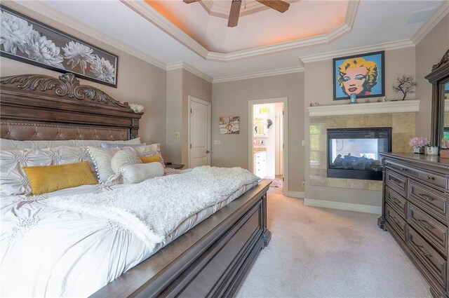 309 E 126th St, Kansas City, MO 64145 - bedroom featuring a tray ceiling, light colored carpet, a tile fireplace, crown molding, and a ceiling fan