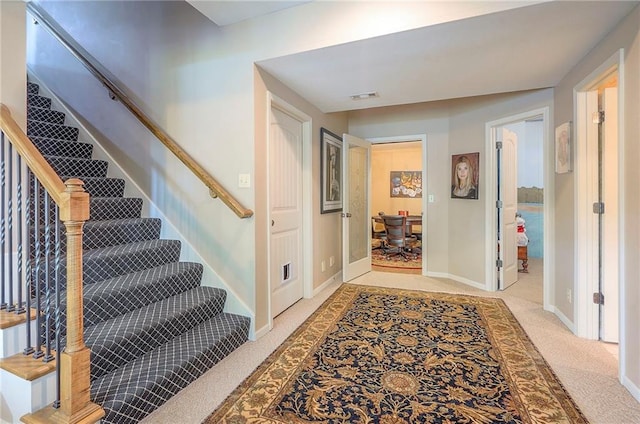 309 E 126th St, Kansas City, MO 64145 - entryway featuring light colored carpet and stairs
