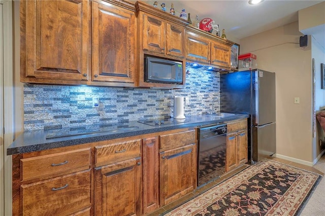 309 E 126th St, Kansas City, MO 64145 - kitchen featuring black appliances, tasteful backsplash, and brown cabinets