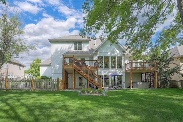 309 E 126th St, Kansas City, MO 64145 - back of property featuring a hot tub, a deck, stairs, and a fenced backyard