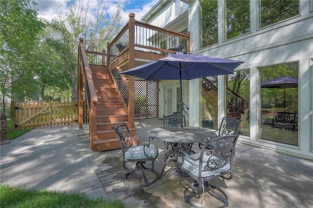 309 E 126th St, Kansas City, MO 64145 - view of patio with stairs, outdoor dining space, and a gate