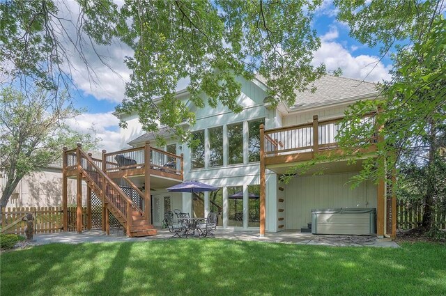 309 E 126th St, Kansas City, MO 64145 - rear view of house featuring a hot tub, a patio, a deck, a shingled roof, and stairway