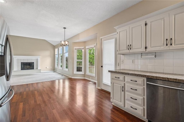 13701 W 149th St, Olathe, KS 66062 - kitchen featuring stainless steel appliances, open floor plan, vaulted ceiling, dark wood finished floors, and decorative backsplash