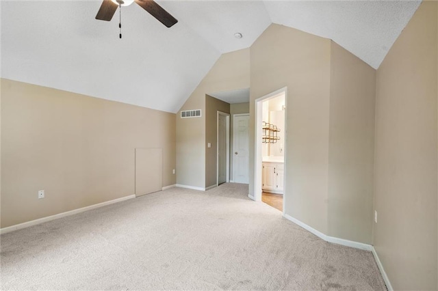 13701 W 149th St, Olathe, KS 66062 - unfurnished bedroom featuring light colored carpet, lofted ceiling, connected bathroom, and ceiling fan