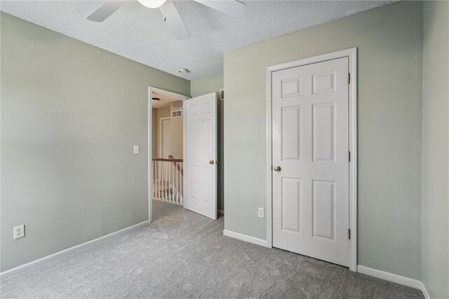 13701 W 149th St, Olathe, KS 66062 - unfurnished bedroom with carpet floors, a textured ceiling, and a ceiling fan