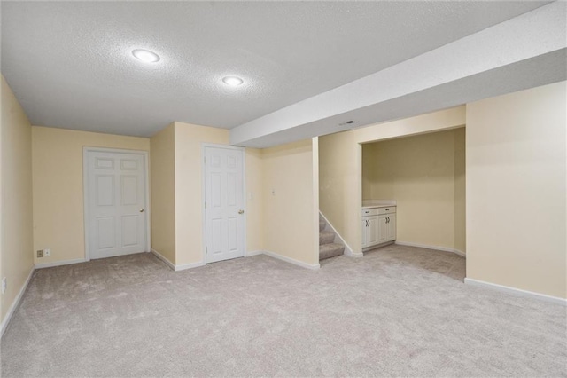 13701 W 149th St, Olathe, KS 66062 - finished below grade area with a textured ceiling, light colored carpet, and stairway