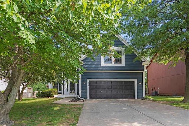 13701 W 149th St, Olathe, KS 66062 - view of property hidden behind natural elements featuring driveway, a garage, and a front lawn