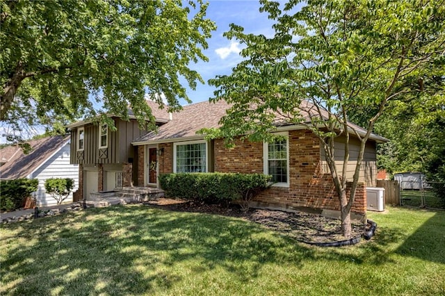 4430 E 107th Ter, Kansas City, MO 64137 - split level home with brick siding and board and batten siding