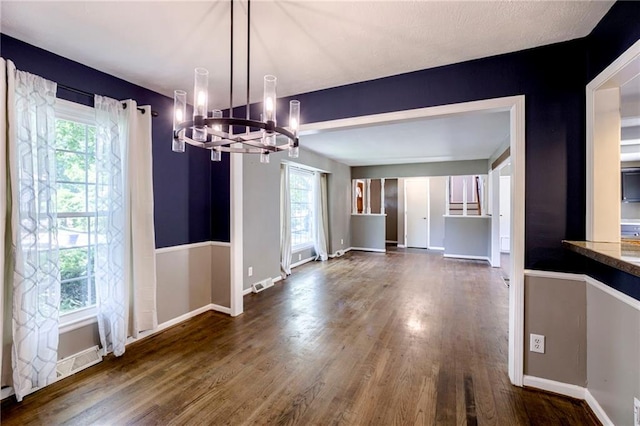 4430 E 107th Ter, Kansas City, MO 64137 - unfurnished dining area featuring a chandelier, dark wood finished floors, and plenty of natural light