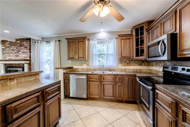 4430 E 107th Ter, Kansas City, MO 64137 - kitchen featuring stainless steel appliances, decorative backsplash, ceiling fan, light tile patterned flooring, and glass insert cabinets
