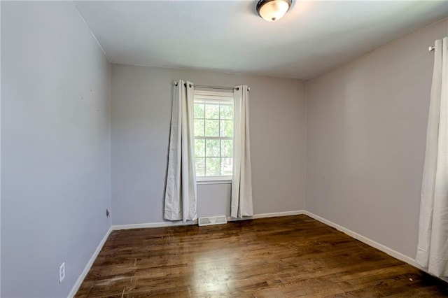 4430 E 107th Ter, Kansas City, MO 64137 - spare room with wood finished floors and baseboards