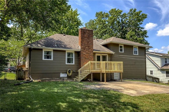 4430 E 107th Ter, Kansas City, MO 64137 - rear view of property with a chimney, a patio, a wooden deck, and roof with shingles