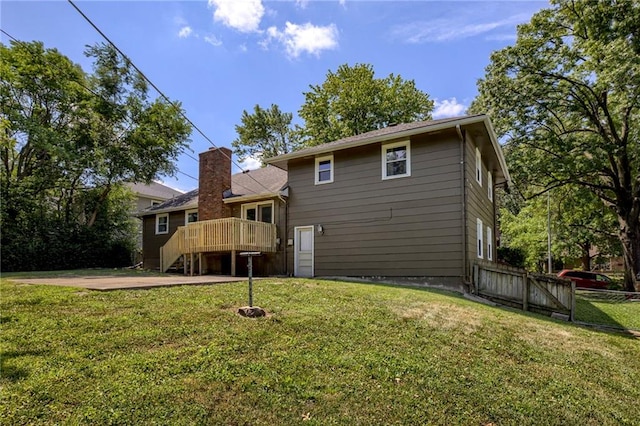 4430 E 107th Ter, Kansas City, MO 64137 - back of house featuring a wooden deck and a patio area