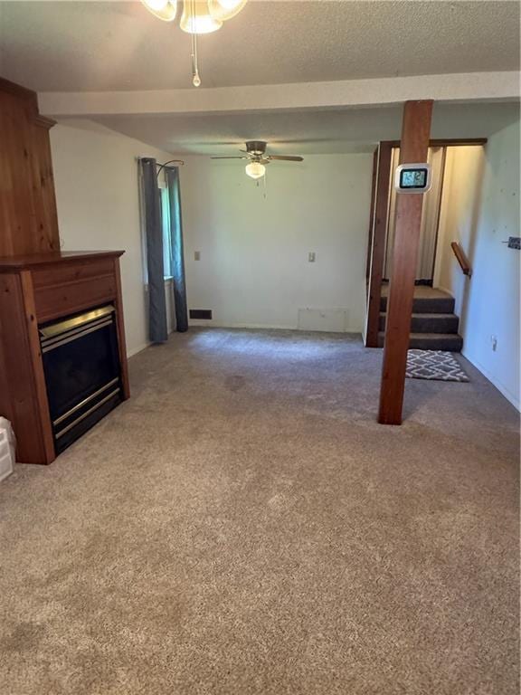 1258 24500th Rd, Parsons, KS 67357 - unfurnished living room featuring carpet flooring, stairs, ceiling fan, and a fireplace