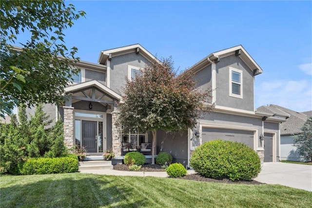 1220 Kingsland Cir, Raymore, MO 64083 - view of front of property with stucco siding, a garage, a front lawn, driveway, and stone siding