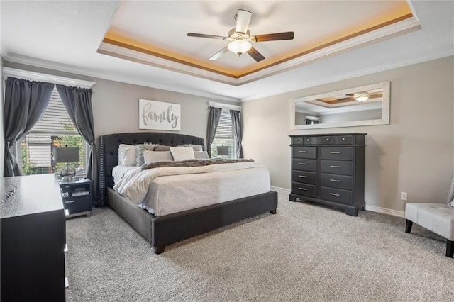 1220 Kingsland Cir, Raymore, MO 64083 - carpeted bedroom featuring a raised ceiling, ornamental molding, and a ceiling fan
