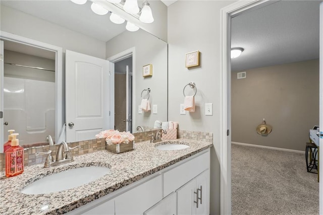 1220 Kingsland Cir, Raymore, MO 64083 - bathroom featuring double vanity and baseboards