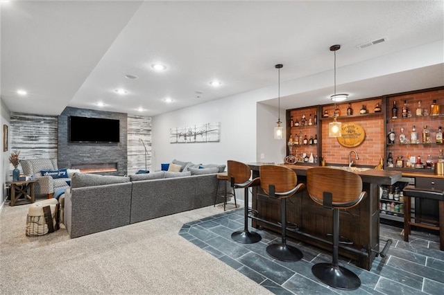 1220 Kingsland Cir, Raymore, MO 64083 - indoor wet bar with recessed lighting, a fireplace, and decorative light fixtures